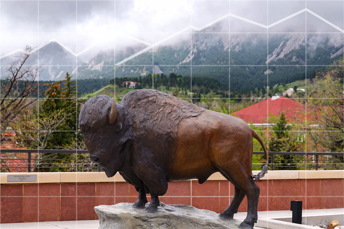 Buffalo statue with the Flat Irons in the background