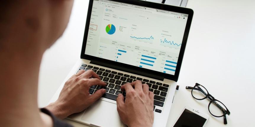 Person looking at data on a laptop 